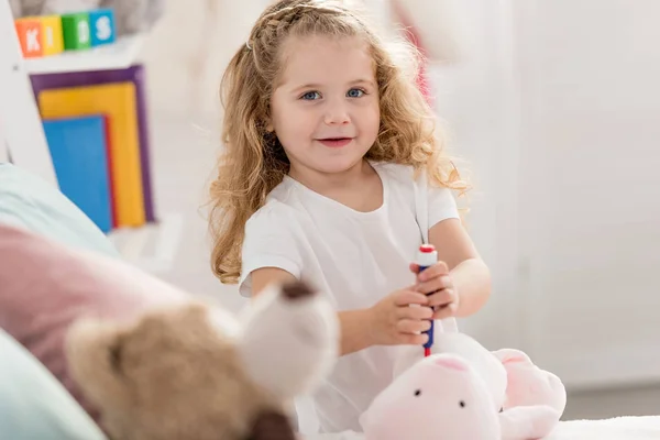 Adorable Kid Playing Rabbit Toy Children Room Looking Camera — Free Stock Photo