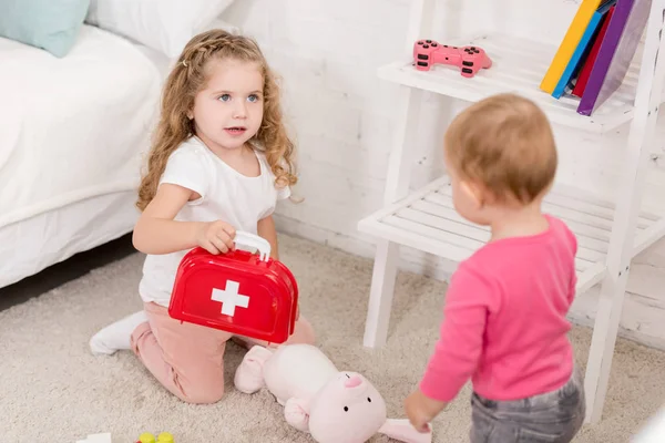 Adorable Sisters Playing First Aid Kit Children Room — Free Stock Photo