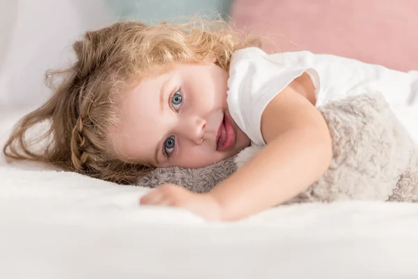 Grimacing Adorable Happy Kid Lying Bed Children Room Looking Camera — Stock Photo, Image