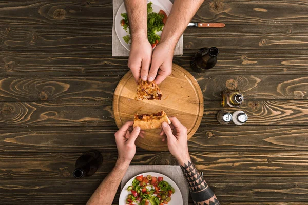 Partial View Men Sharing Slice Pizza Meal Wooden Table — Stock Photo, Image