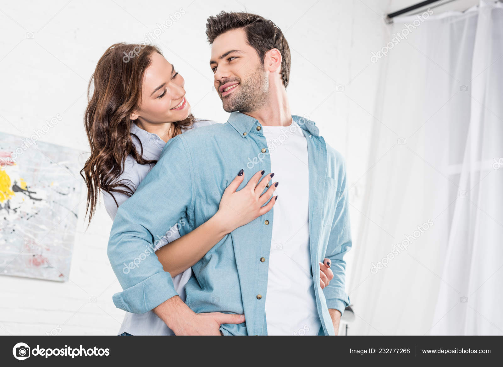 Woman Hugging Handsome Man Home Stock Photo by ©EdZbarzhyvetsky 232777268