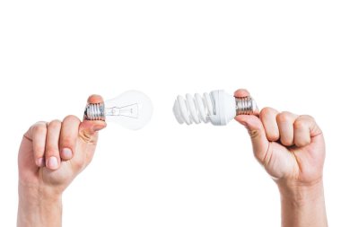 cropped view of choice between led and fluorescent lamps in male hands isolated on white, energy efficiency concept  clipart