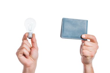 cropped view of male hands holding led lamp and wallet in hands isolated on white, energy efficiency concept clipart