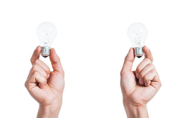 cropped view of led lamps in male hands isolated on white, energy efficiency concept