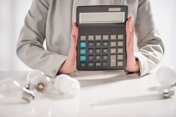 Cropped View Woman Holding Calculator Lamps White Background Energy Efficiency — Stock Photo, Image