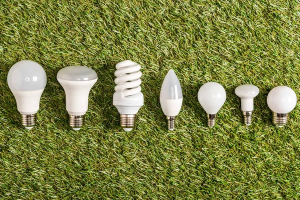 Flat Lay Fluorescent Lamps Green Grass Energy Efficiency Concept — Stock Photo, Image