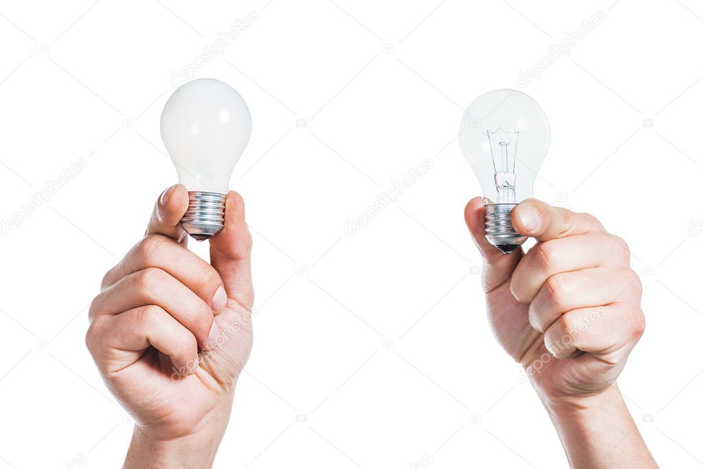 cropped view of male hands holding led lamps in hands isolated on white, energy efficiency concept