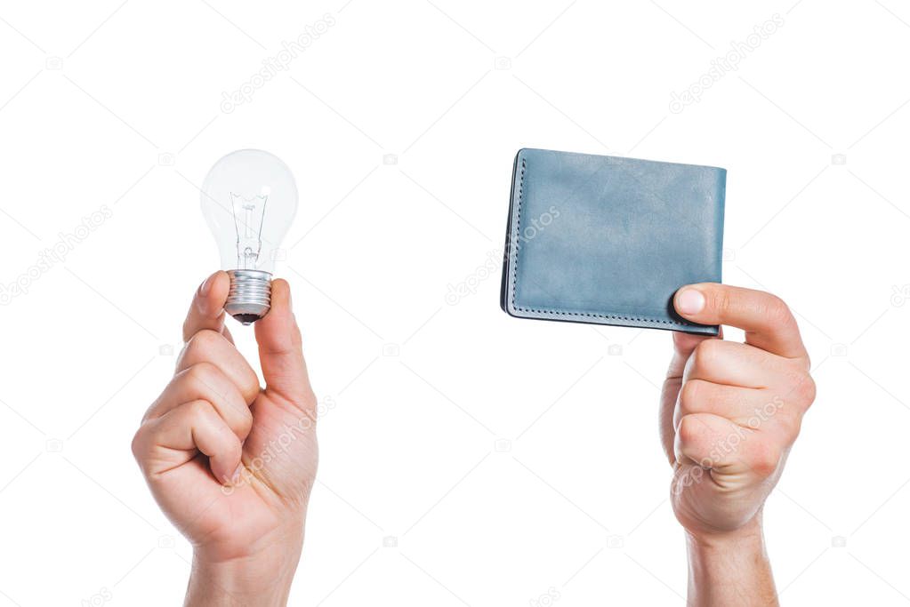 cropped view of male hands holding led lamp and wallet in hands isolated on white, energy efficiency concept