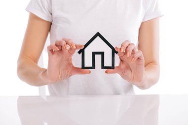 partial view of woman holding house model in hands isolated on white, mortgage concept clipart