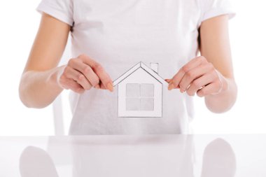 partial view of woman holding paper house isolated on white, mortgage concept clipart