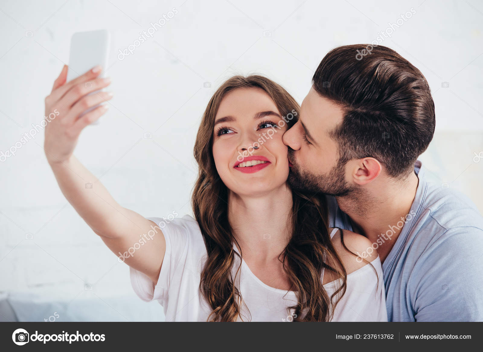 Boyfriend Kissing Girlfriend While Taking Selfie Bedroom Stock Photo
