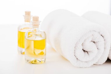 Studio shot of towels and bottles of manicure oil isolated on white clipart