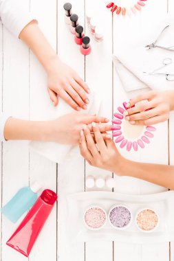 Top view of manicurist choosing nail polish color clipart