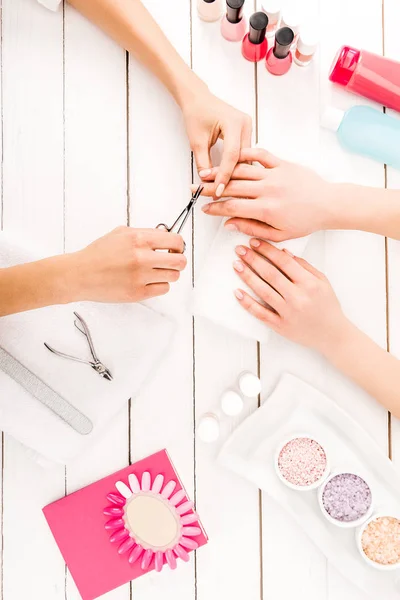 Top View Manicurist Cutting Nails Wooden Surface — Stock Photo, Image