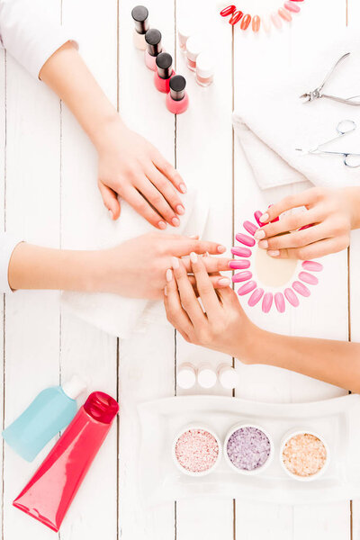 Top view of manicurist choosing nail polish color