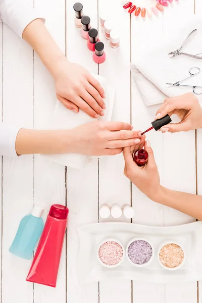 Cropped View Woman Holding Hands Wooden Surface While Manicurist Applying — Stock Photo, Image