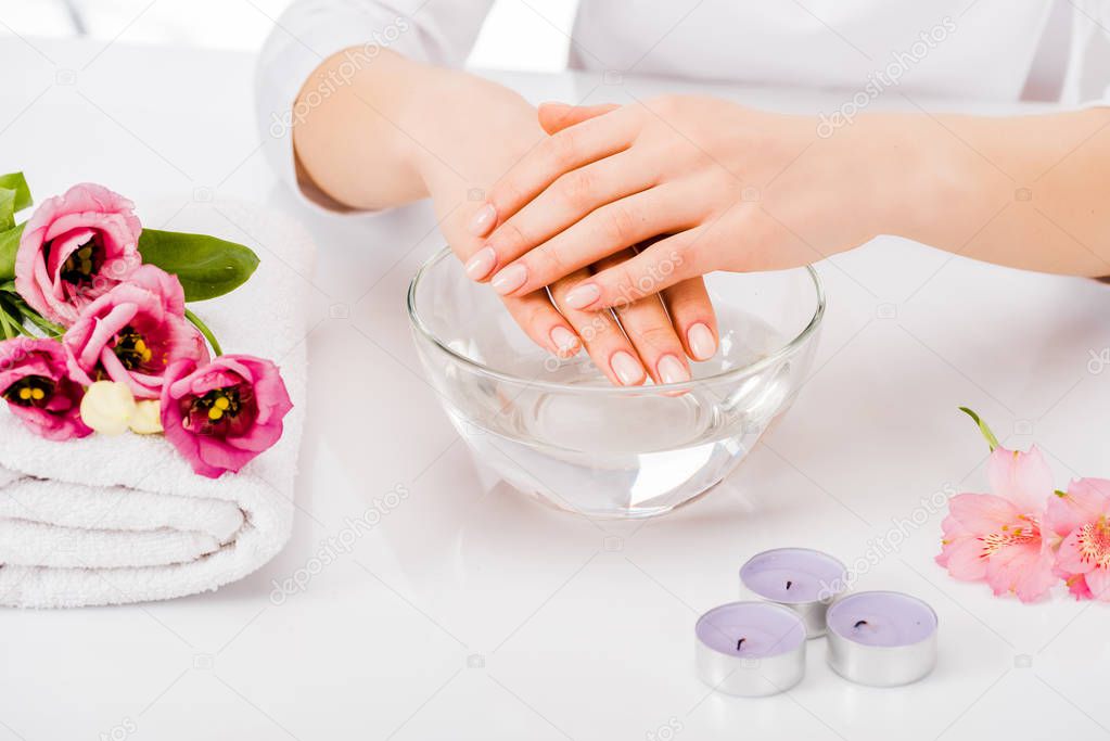 Cropped view of woman with beautiful hands posing after nail bath