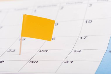 selective focus of yellow flag on number 22 in calendar clipart