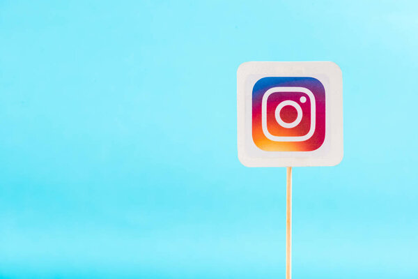top view of instagram logo solated on blue with copy space