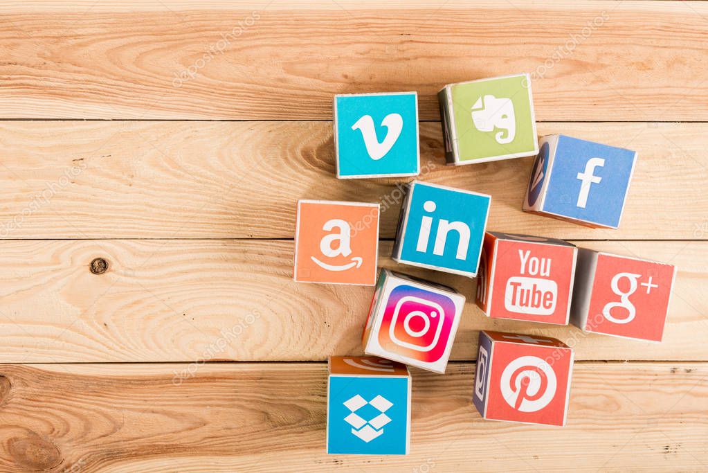 Top view of website and app icons on wooden background