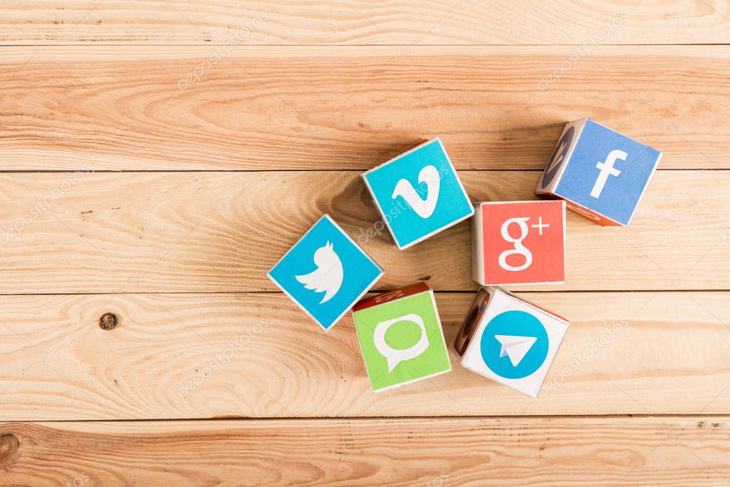 Top view of website and app icons on wooden background