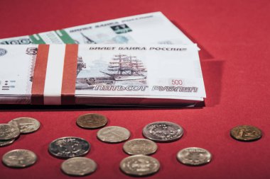 close-up view of russian rubles coins and banknotes on red clipart