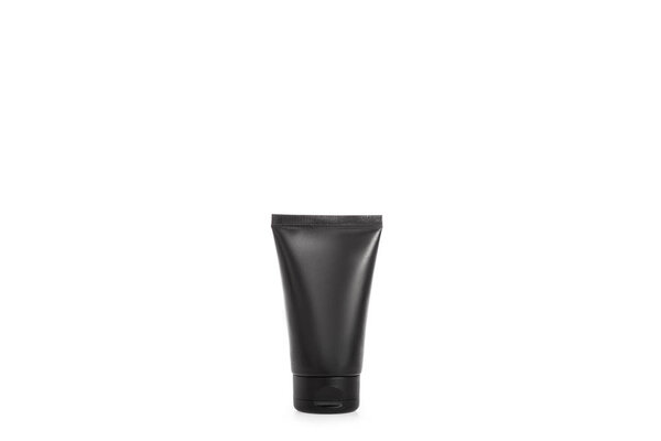 Studio shot of black cream tube isolated on white