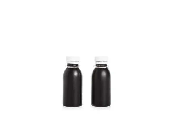Δύο Μαύρα Πλαστικά Μπουκάλια Που Απομονώνονται Λευκό — Φωτογραφία Αρχείου