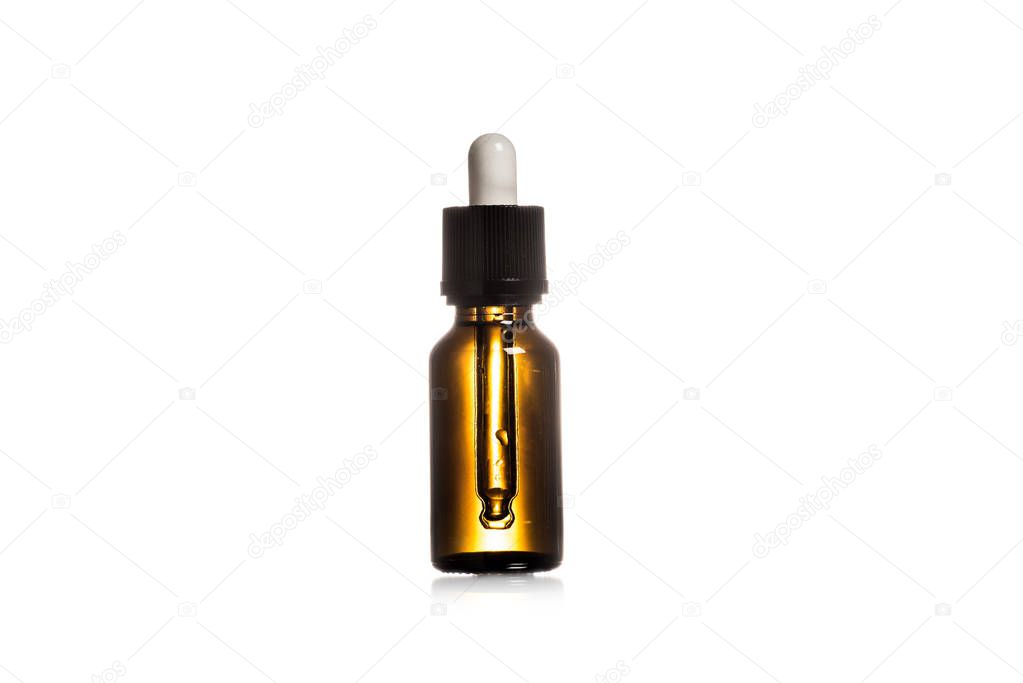 Studio shot of brown glass bottle with pepitte isolated on white