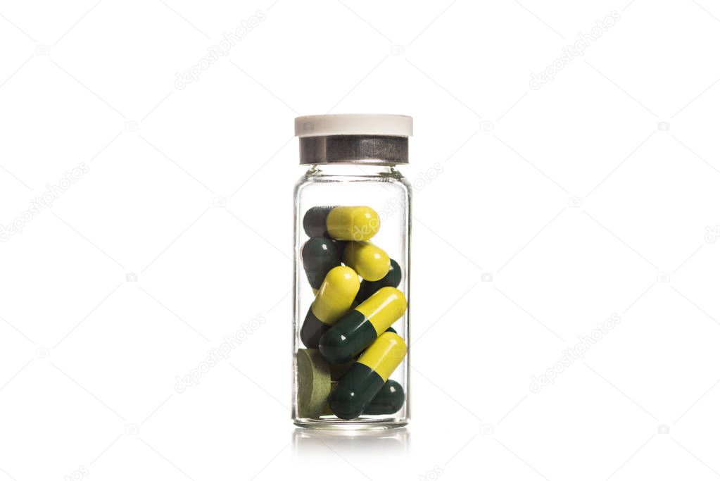 Studio shot of glass container with pills isolated on white