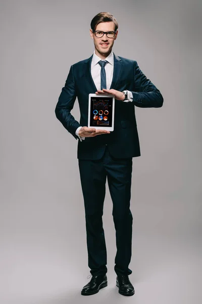 Handsome Businessman Holding Digital Tablet Charts Graphs Screen Grey Background — Stock Photo, Image