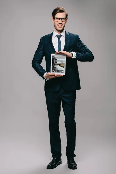 Handsome Businessman Holding Digital Tablet Tickets App Screen Grey Background — Stock Photo, Image