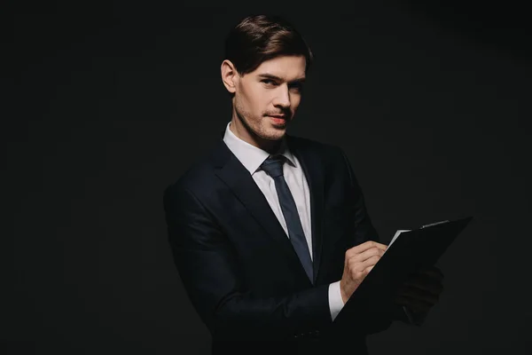 Handsome Businessman Holding Clipboard Isolated Black — Stock Photo, Image