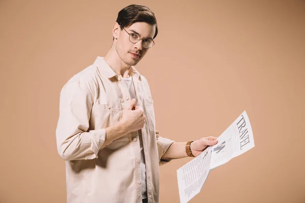 Hombre Guapo Mirando Cámara Mientras Sostiene Periódico Viaje Aislado Beige —  Fotos de Stock