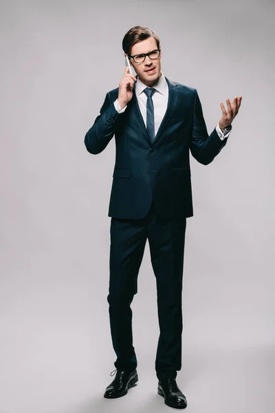 Handsome Businessman Talking Smartphone While Standing Suit Grey Background — Stock Photo, Image