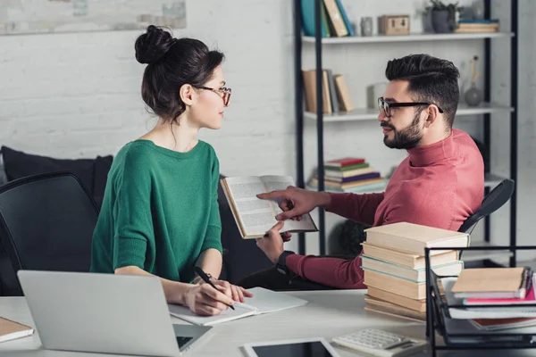 Handsome Man Pointing Finger Book Attractive Coworker Modern Office — Stock Photo, Image