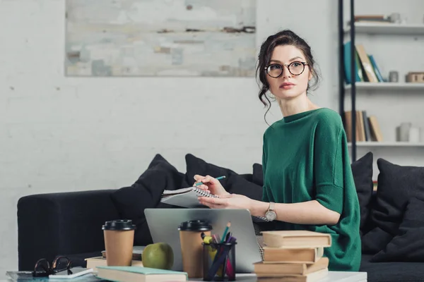 Thoughtful Woman Glasses Writing Notebook Home — Stock Photo, Image