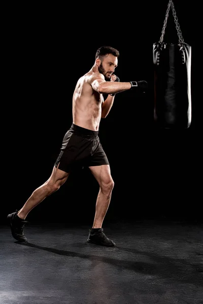 Shortless Bearded Man Kicking Punching Bag Black Background — Stock Photo, Image