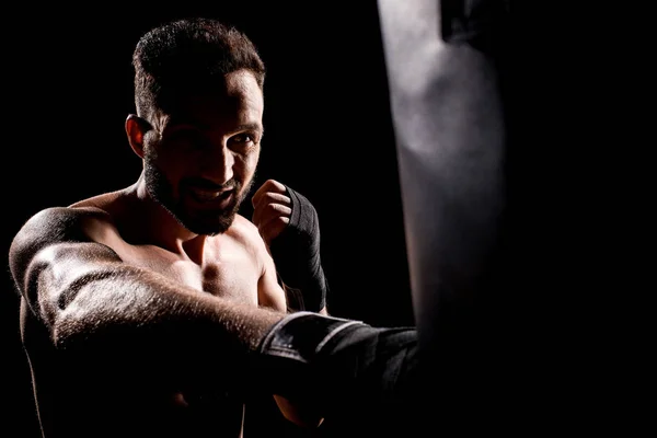 Shortless Sportsman Hitting Punching Bag Isolated Black — Stock Photo, Image