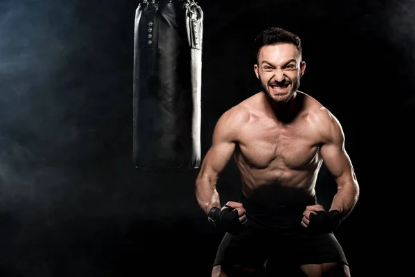 Angry Boxer Showing Muscles Punching Bag Black Smoke — Stock Photo, Image