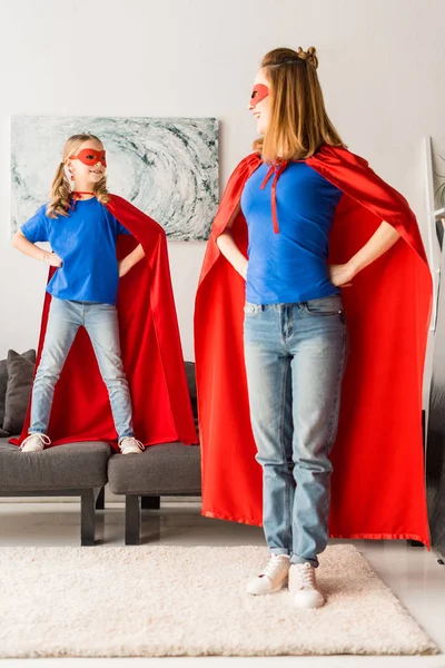 Cute Daughter Mother Red Cloaks Masks Looking Each Other — Stock Photo, Image