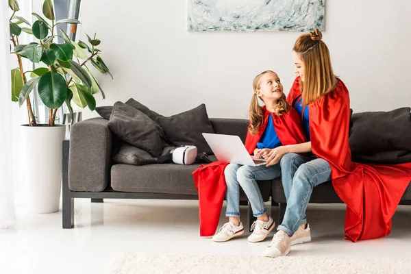 Cute Kid Beautiful Mother Red Cloaks Sitting Sofa Holding Laptop — Stock Photo, Image