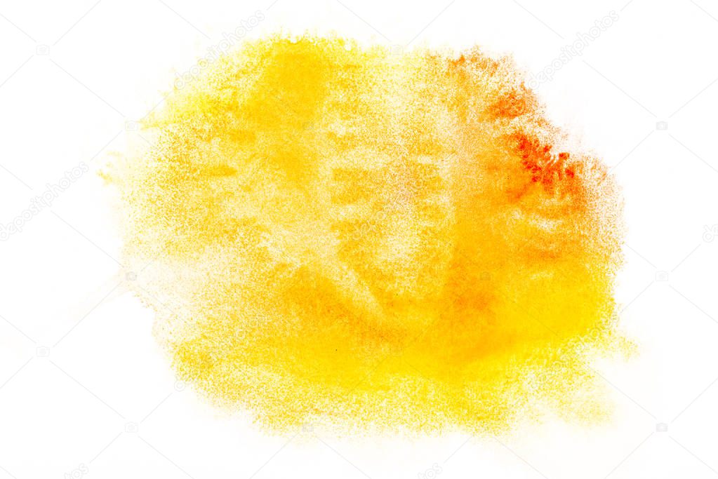 top view of yellow and orange watercolor spills on white paper 