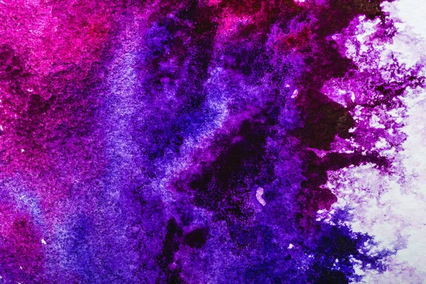 top view of purple and pink watercolor spills on white background 