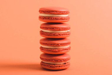 stack of coral macarons on coral background, color of 2019 concept clipart