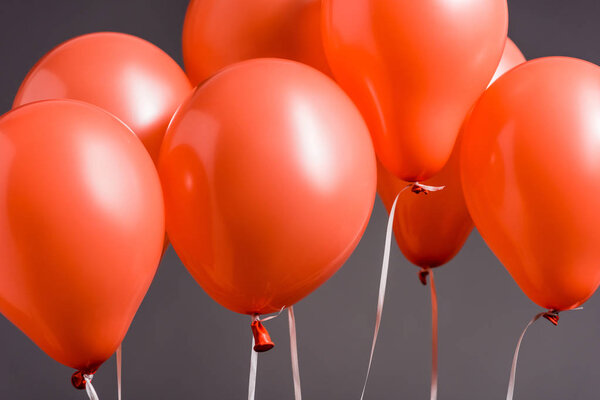 bright coral air balloons on grey background, color of 2019 concept