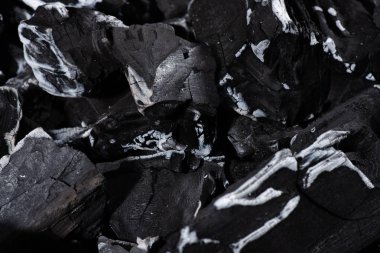 close up of black burnt textured charcoal with white ash clipart