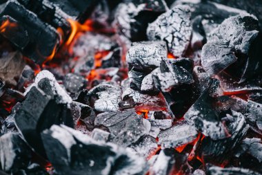 selective focus of hot burning coals in white ash clipart
