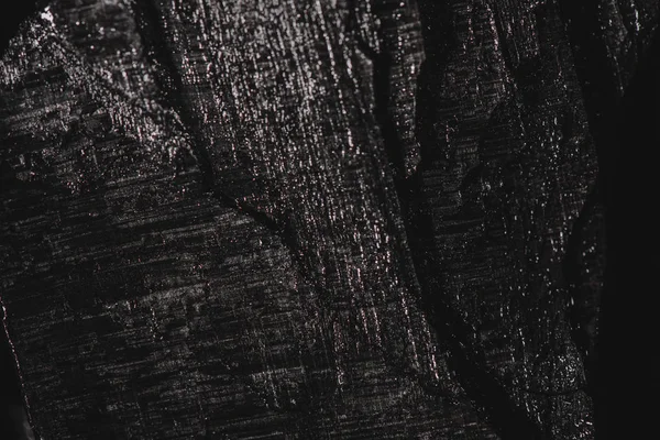 dark black background of textured charcoal with copy space