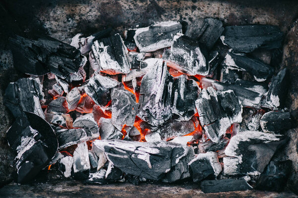 top view of hot burning coals with ash in fireplace